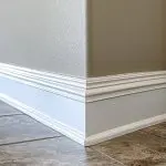 Interior wall corner and baseboard painted with a durable finish, showing how to choose interior paint finishes for high-traffic areas.