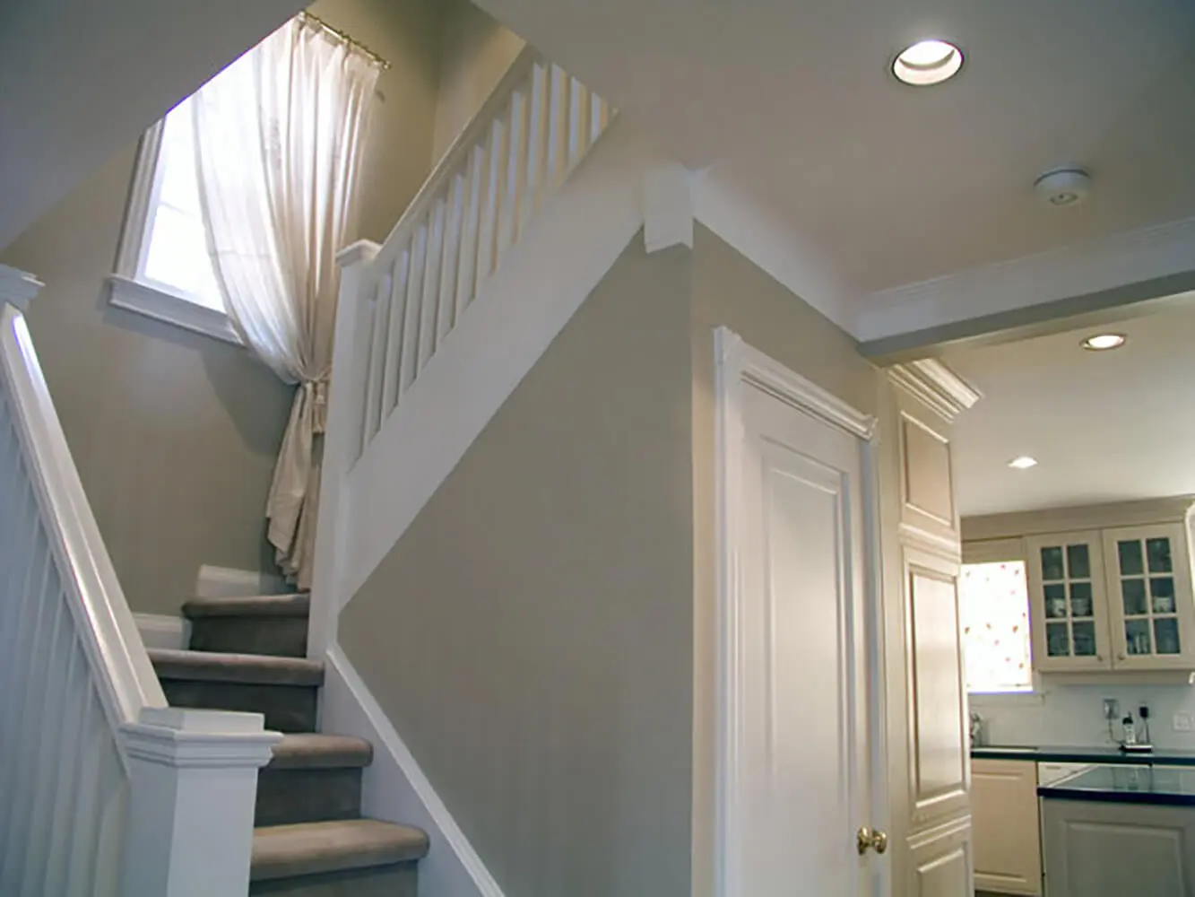 Freshly painted interior stairwell and hallway showing how to prepare your home for a professional interior painting project