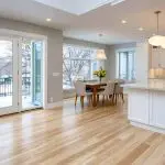 Open-concept interior with connected kitchen and dining area showing what to consider before painting an open-concept interior, including light flow and color continuity.